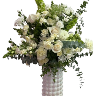 White sympathy bouquet of roses and carnations in a bubble-textured ceramic vase