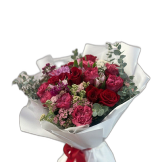 Blush pink peony, rose, and gerbera bouquet in pink wrap