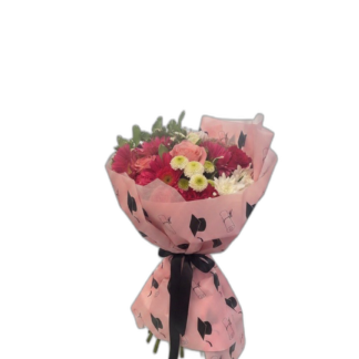 Pink gerbera, rose, and chrysanthemum graduation bouquet in pink cap-print wrap