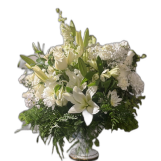 White lily, rose, and chrysanthemum sympathy arrangement in a decorative vase