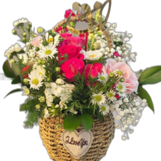 Pink rose and white daisy arrangement in a woven basket with heart charm